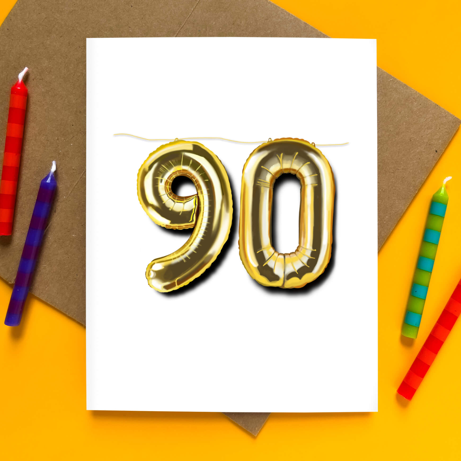 Greeting card with large gold balloon numbers “90” on a white background, festive birthday celebration design.