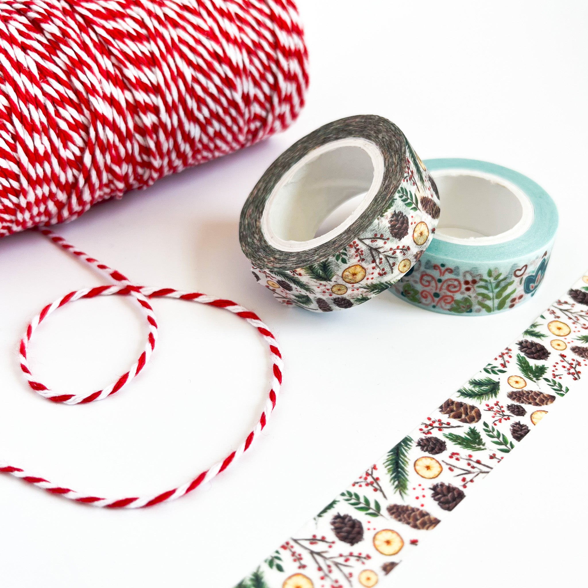 White washi tape with illustrations of pinecones, greenery, and orange slices