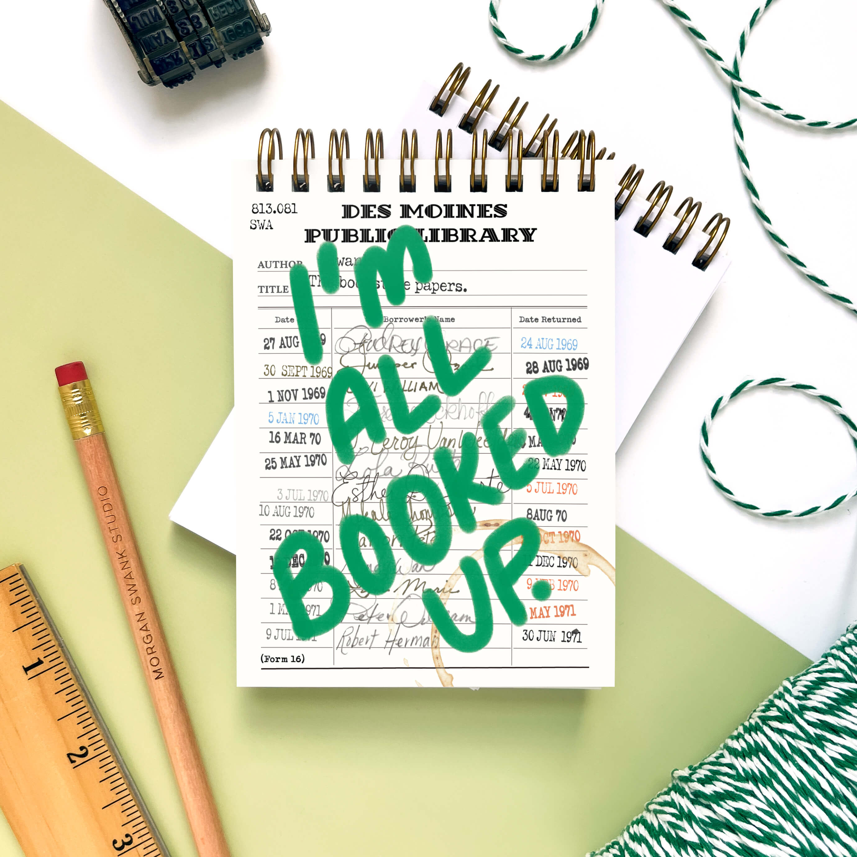 Handmade mini notebook with vintage library card design and green “I’m All Booked Up” lettering