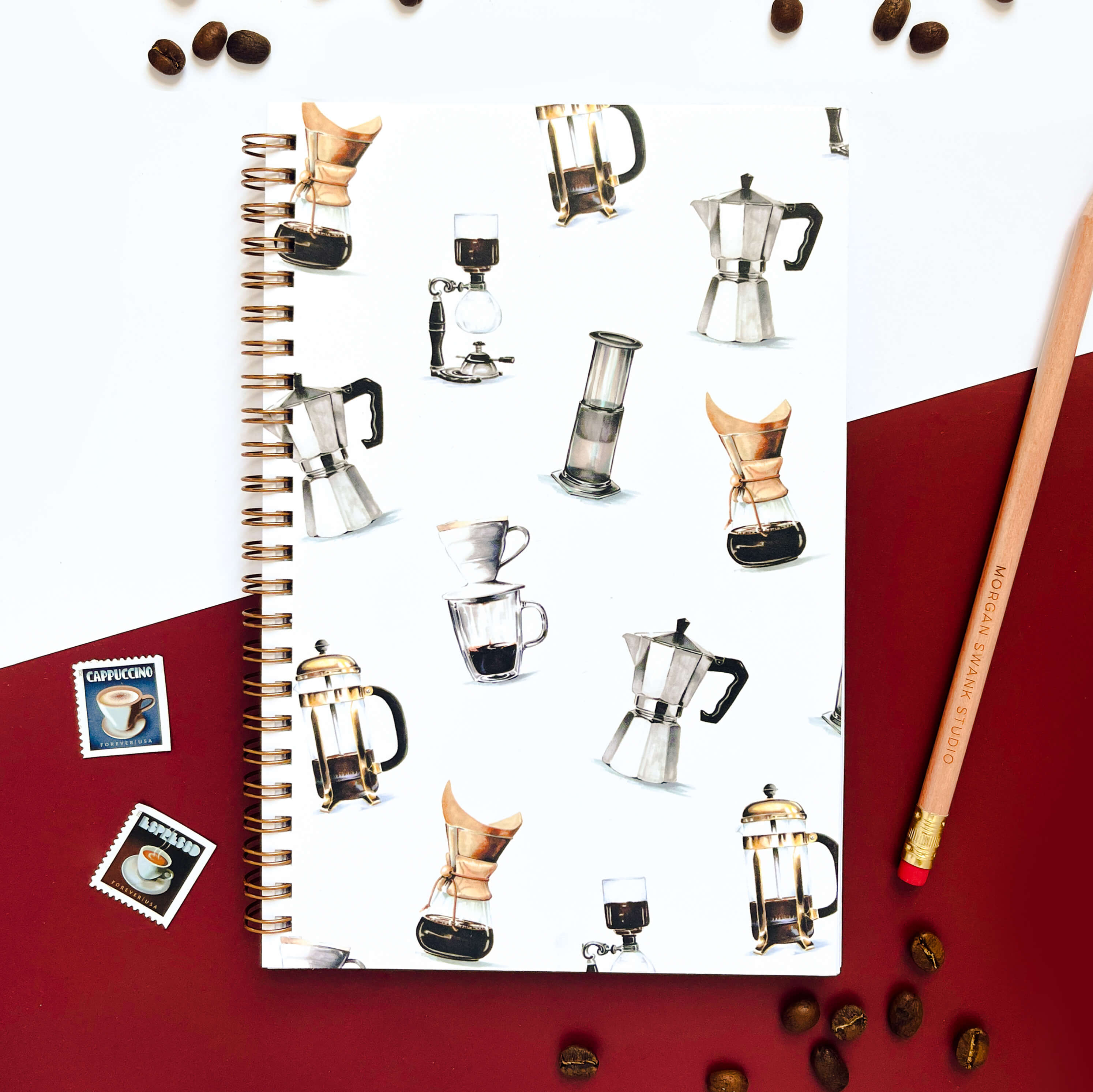 Notebook with illustrated coffee makers and brewers on a white background.