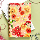 Notebook with yellow, red, and orange daisies and wildflowers.