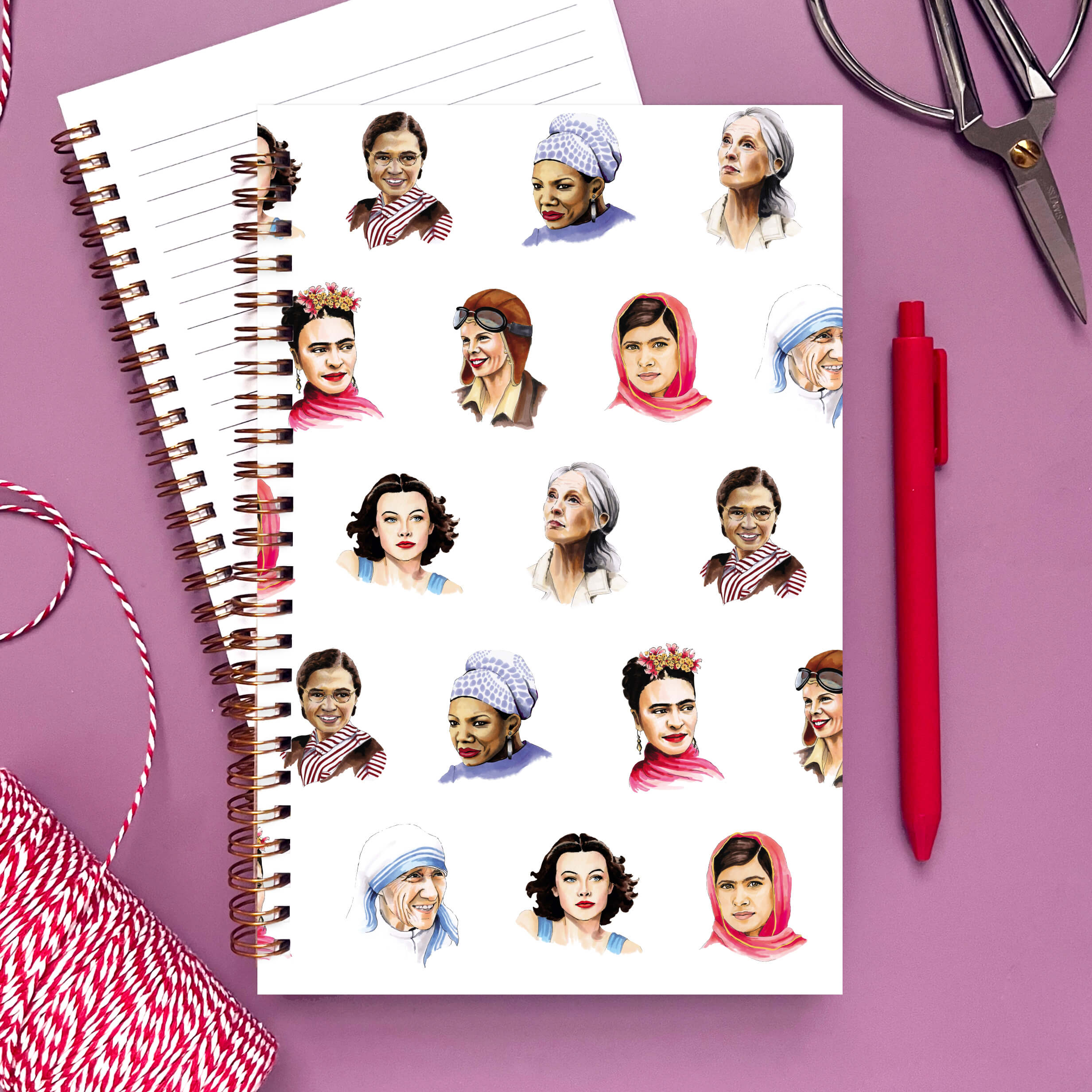 Notebook with portraits of famous women on a white background.