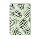 Notebook with watercolor green palm leaves on a light green background.