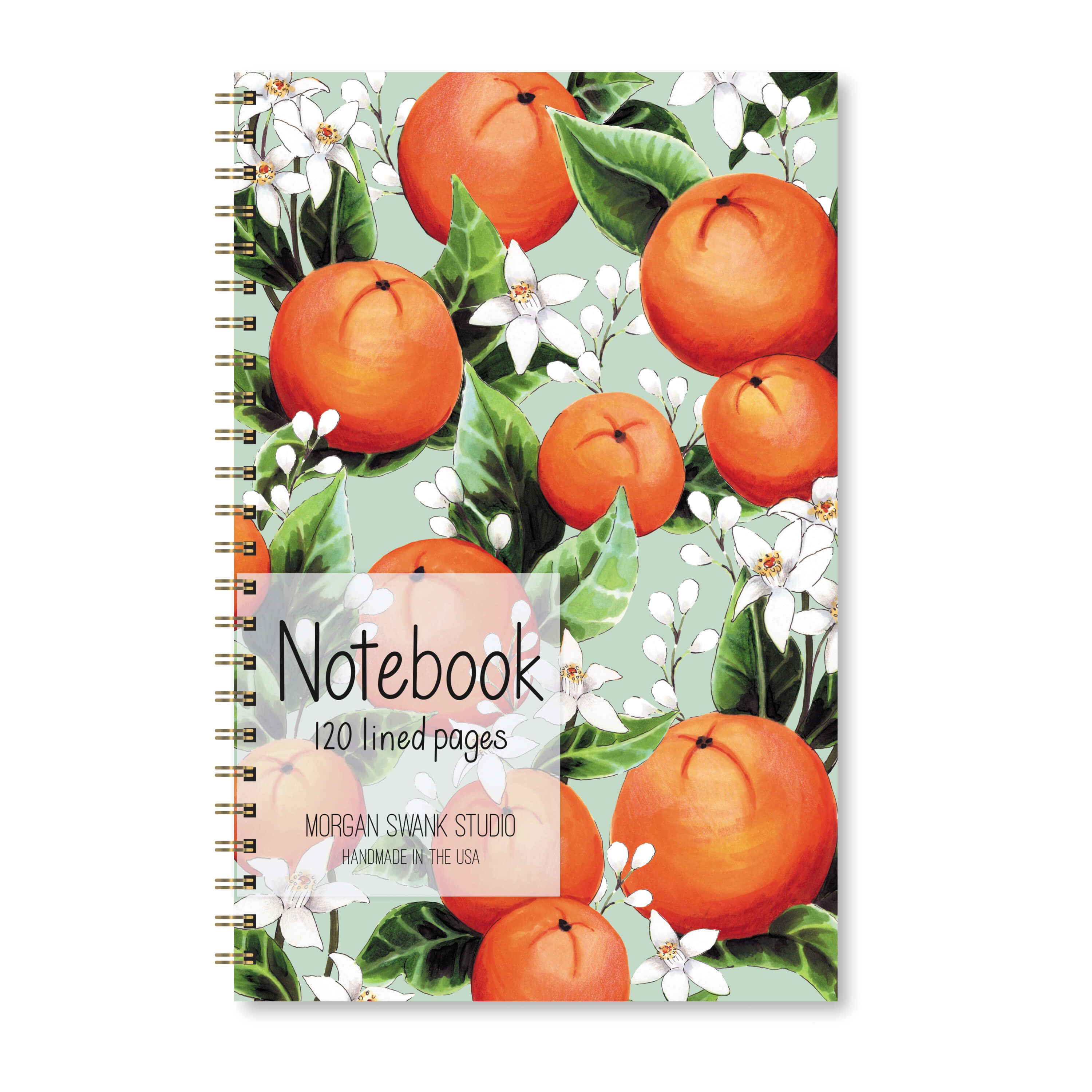 Notebook with orange fruit and white orange blossoms on a green background.