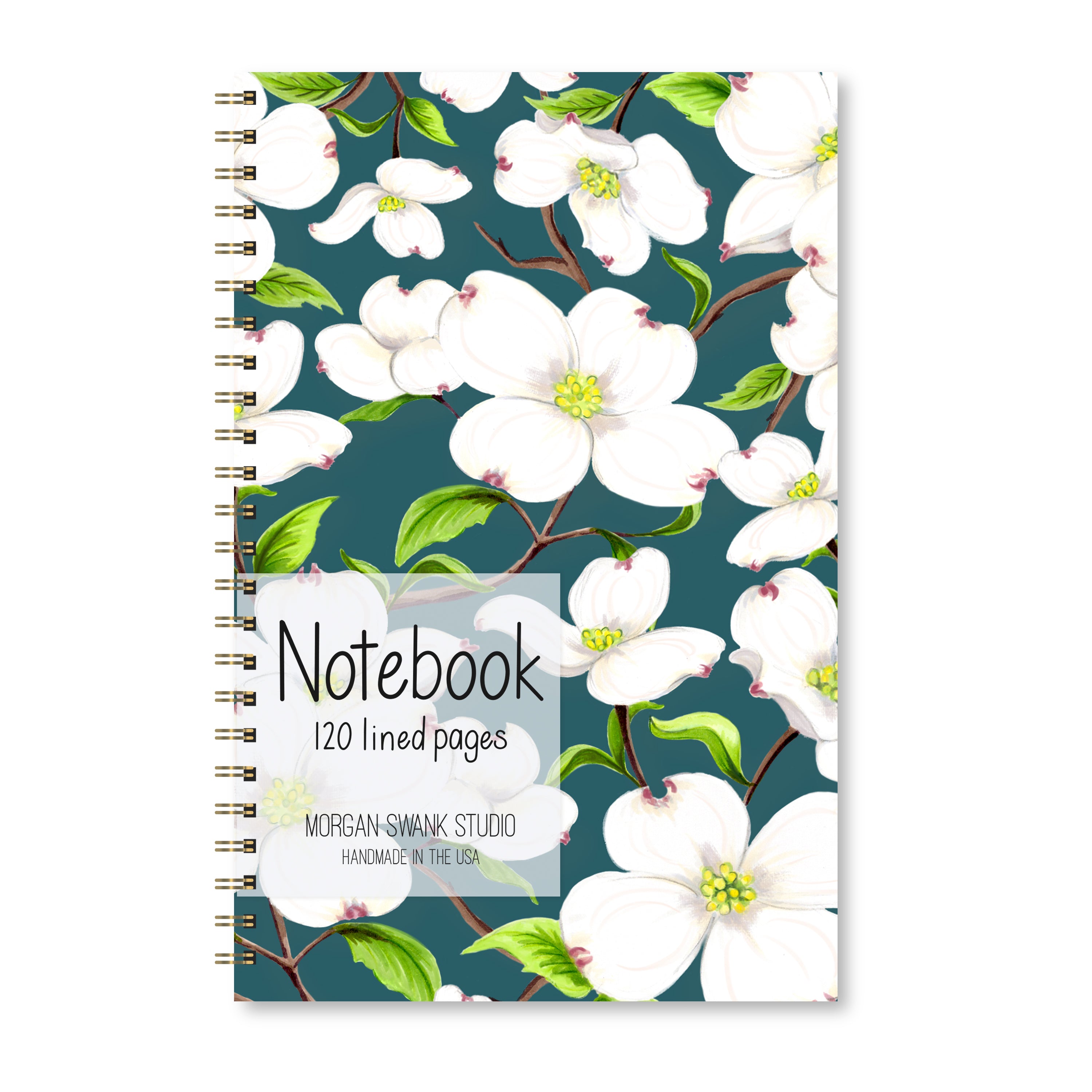 Notebook with white dogwood flowers on a dark green background.