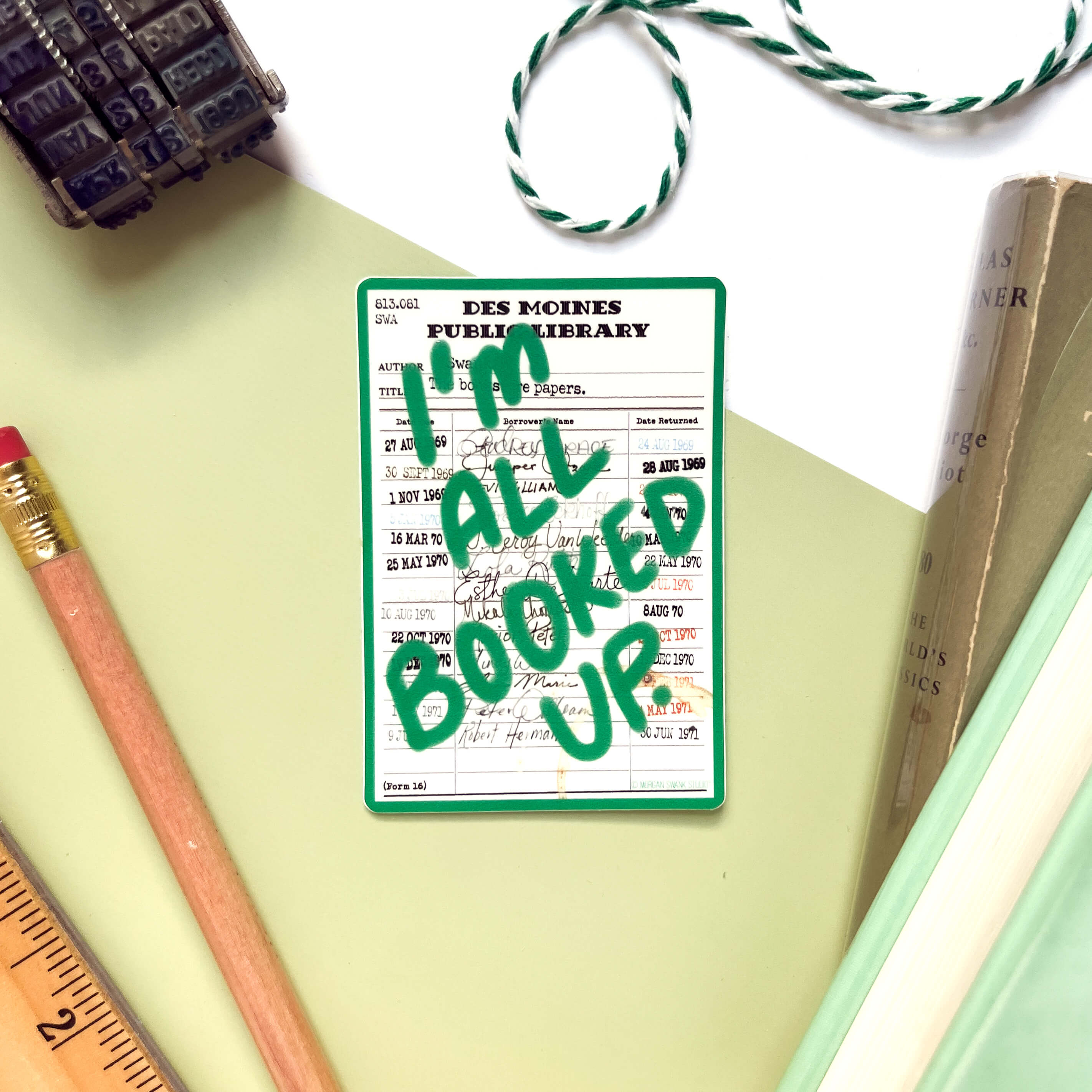 “I’m All Booked Up” green waterproof sticker with vintage library card design