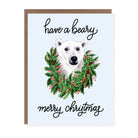 Christmas card with illustrated polar bear in a holiday wreath and the text 'have a beary merry Christmas' on a light blue background.