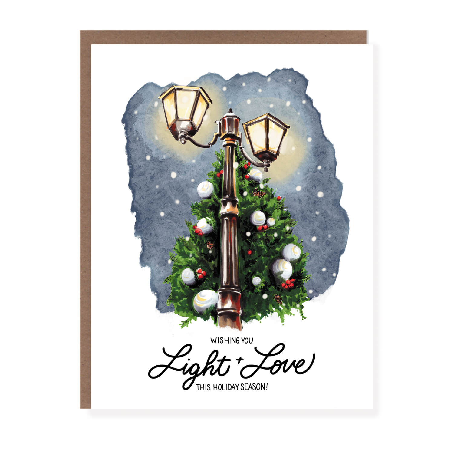Christmas card featuring a glowing vintage streetlamp surrounded by a decorated evergreen tree, with the text 'Wishing you light + love this holiday season.'