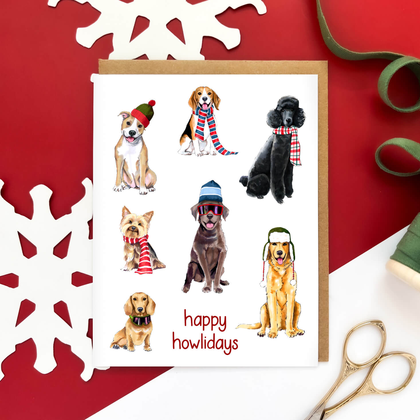 Greeting card featuring a group of illustrated dogs in winter hats and scarves with the text 'happy howlidays' at the bottom.