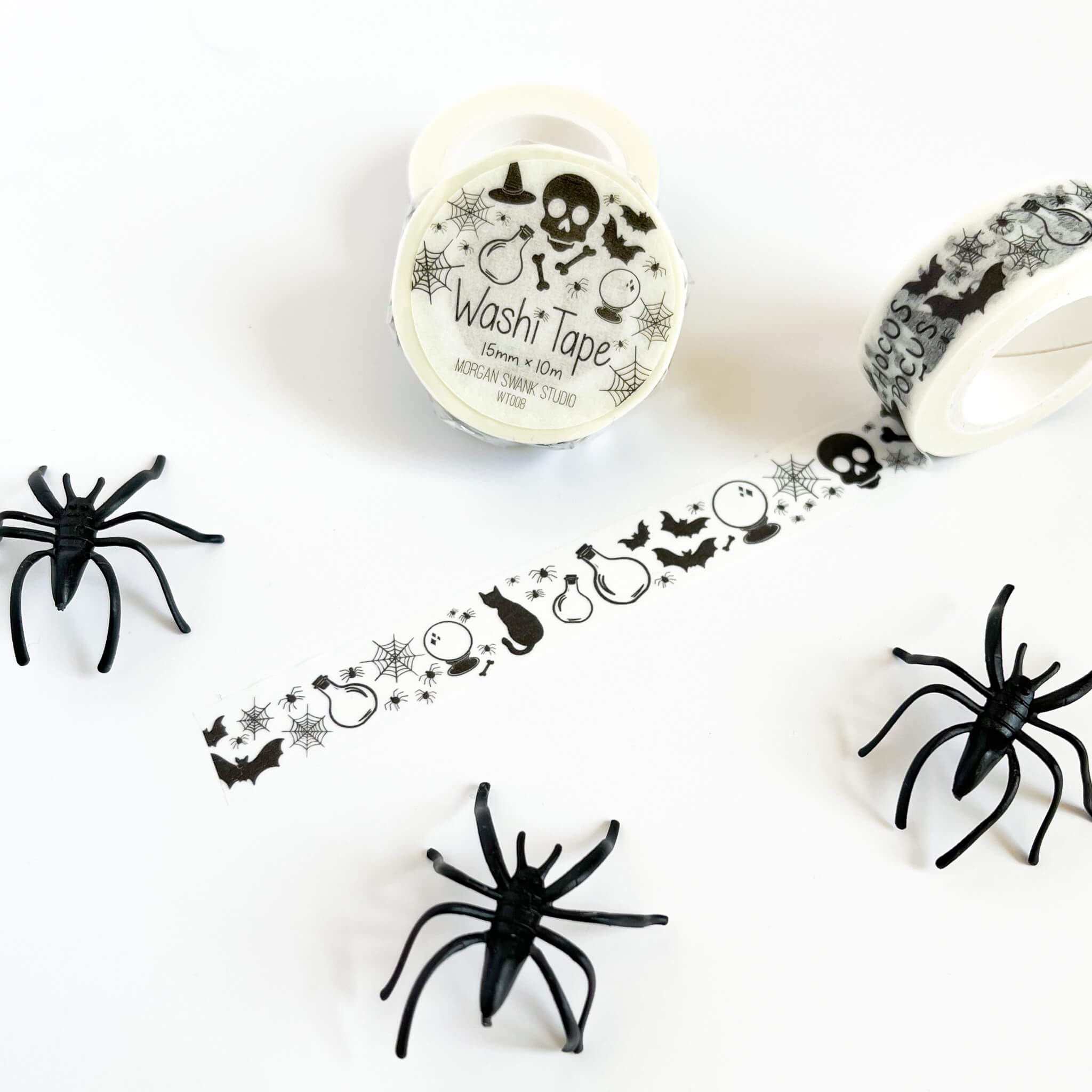 White washi tape with black Halloween illustrations and text 'Hocus Pocus'