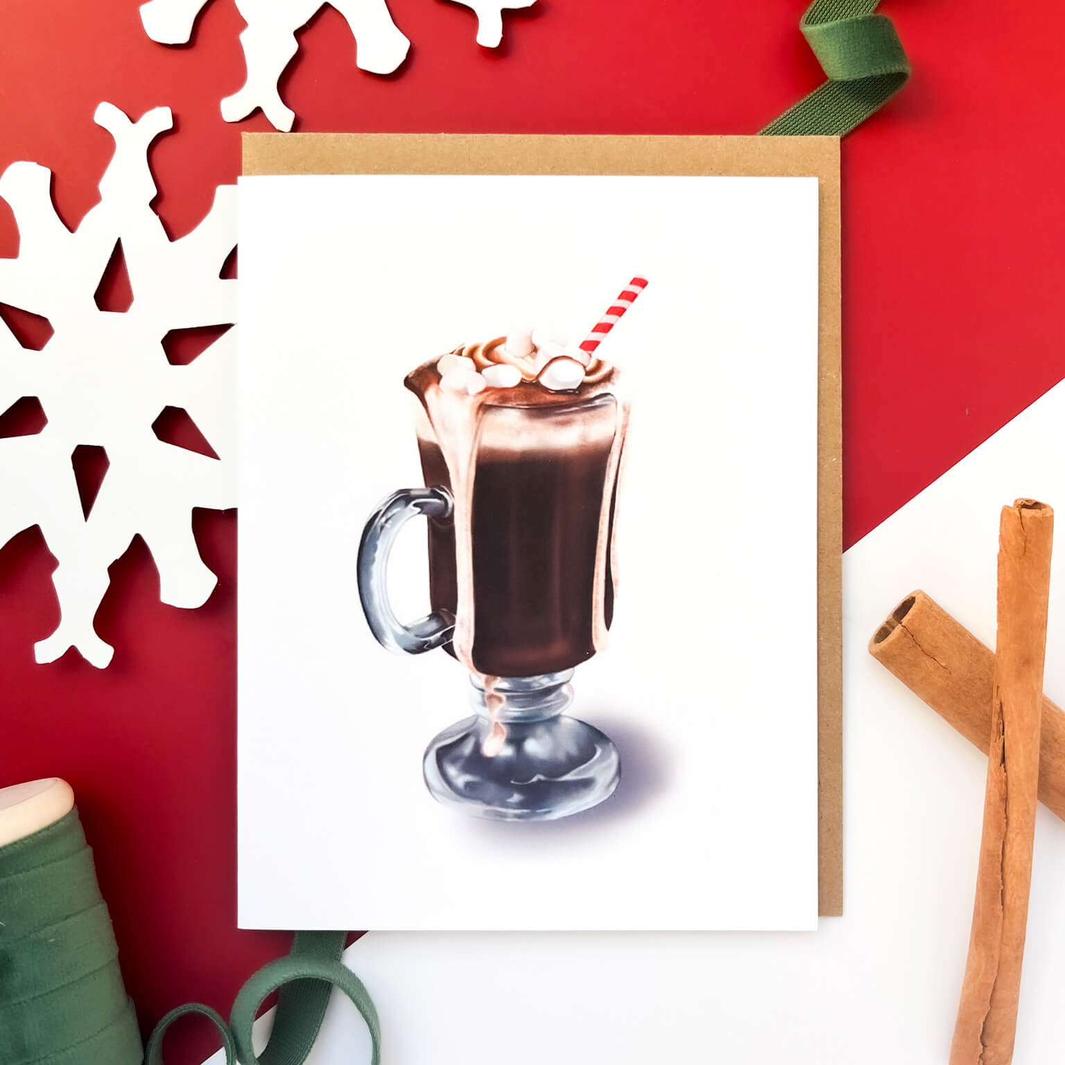 Christmas card featuring a glass mug of overflowing hot chocolate topped with whipped cream, marshmallows, and a red-striped straw.