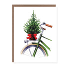 Christmas card with a green bicycle carrying a small decorated tree tied with a red bow on the back.