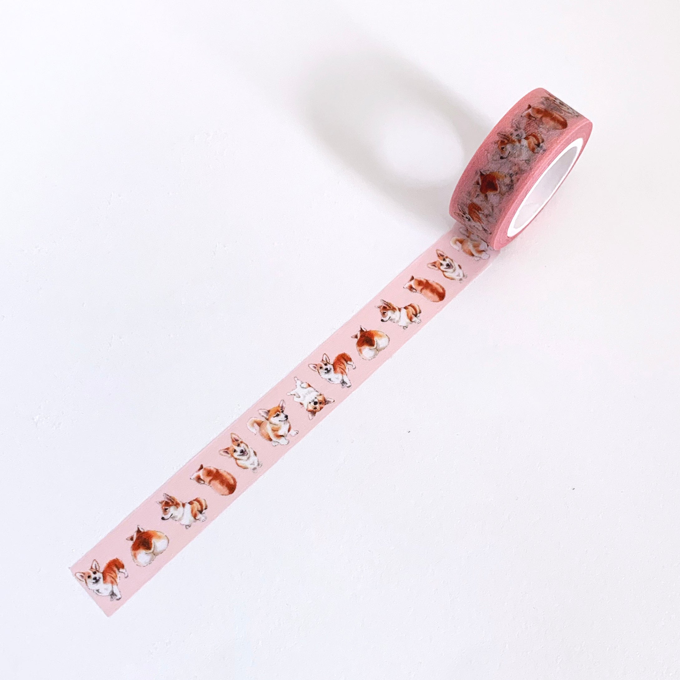 Pink washi tape with illustrated pembroke welsh corgis in various poses