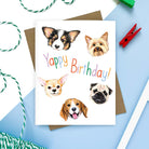 Birthday card featuring hand-drawn illustrations of dog faces with “Yappy Birthday!” text in colorful letters.
